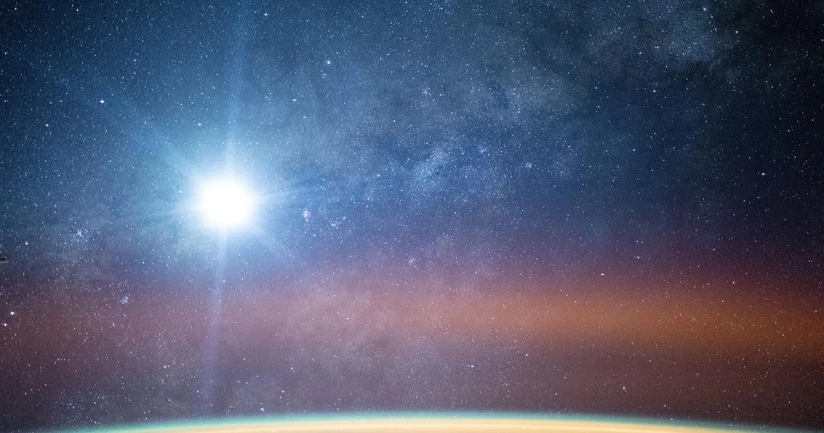 La Via Lattea illumina il cielo notturno sopra l'orizzonte terrestre